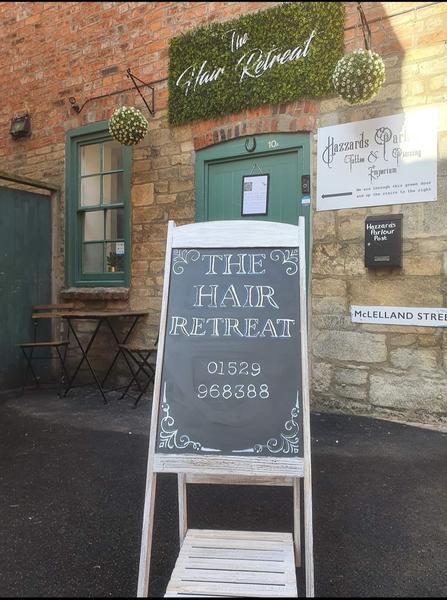 The old entrance with a chalkboard sign and the McLelland Street sign